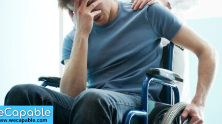 This image shows a wheelchair user depressed due to his disability