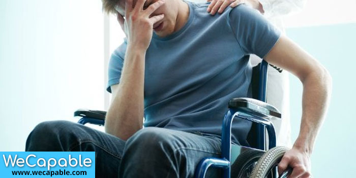 This image shows a wheelchair user depressed due to his disability