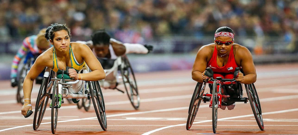 women with disabilities competing in wheelchair race in Paralympics.