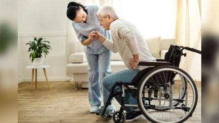 a wheelchair user is standing up from his wheelchair