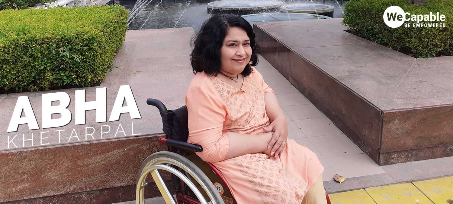 Abha Khetarpal sitting in her wheelchair at a public place