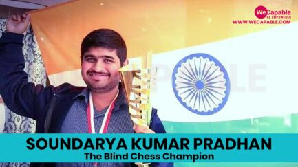 Photograph of soundarya kumar pradhan. He is holding a chess trophy and the Indian flag in background.